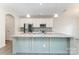 Modern kitchen with a large center island, stainless steel appliances, white cabinets, and hardwood flooring at 829 River Park Rd, Belmont, NC 28012