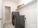 Convenient laundry room equipped with modern washer, dryer, and ample storage space at 829 River Park Rd, Belmont, NC 28012