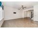 Hardwood floor living room featuring neutral paint, ceiling fan, and staircase at 829 River Park Rd, Belmont, NC 28012