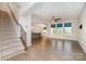 Bright living room with hardwood floors, large windows, and an open layout flowing into the kitchen at 829 River Park Rd, Belmont, NC 28012
