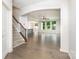 Open-concept living area featuring hardwood floors, a staircase with iron spindles, and ample natural light at 829 River Park Rd, Belmont, NC 28012
