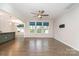 Spacious living room with hardwood floors, large windows, and an open layout flowing into the kitchen at 829 River Park Rd, Belmont, NC 28012