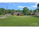 Spacious backyard with a covered porch, patio, and grassy area at 1000 Peachtree Rd, Charlotte, NC 28216