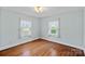 Bright bedroom features hardwood floors, neutral walls, and natural light at 1000 Peachtree Rd, Charlotte, NC 28216