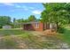 Charming brick ranch with mature trees, a carport, and covered porch at 1000 Peachtree Rd, Charlotte, NC 28216