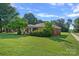 All brick home situated on a lush green lawn with a sidewalk and mature shade trees at 1000 Peachtree Rd, Charlotte, NC 28216