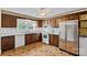 Well-lit kitchen with wooden cabinets and white appliances at 1000 Peachtree Rd, Charlotte, NC 28216