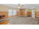 Comfortable living room with vintage paneled walls, ceiling fan, and generous natural light at 1000 Peachtree Rd, Charlotte, NC 28216