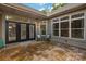 Charming outdoor patio with stone flooring, and chairs, adjacent to house with large windows at 10502 Old Ardrey Kell Rd, Charlotte, NC 28277