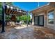 Outdoor patio with stone floor and modern striped canopy perfect for outdoor dining and relaxation at 10502 Old Ardrey Kell Rd, Charlotte, NC 28277