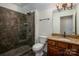 Full bathroom boasts a tiled shower with glass door, and vanity with granite countertop and wood cabinets at 10502 Old Ardrey Kell Rd, Charlotte, NC 28277