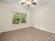 Bright bedroom with a ceiling fan, large window, and modern flooring at 10502 Old Ardrey Kell Rd, Charlotte, NC 28277