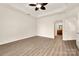 Bright and open bedroom featuring modern floors, a ceiling fan, and easy access to other living spaces at 10502 Old Ardrey Kell Rd, Charlotte, NC 28277