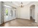 Cozy dining area with large windows, double doors and chandelier lighting at 10502 Old Ardrey Kell Rd, Charlotte, NC 28277