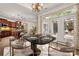 Bright dining room offers a modern table set and connection to the outdoor patio at 10502 Old Ardrey Kell Rd, Charlotte, NC 28277
