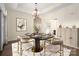 Elegant dining room showcases modern decor, a statement chandelier, and lots of space at 10502 Old Ardrey Kell Rd, Charlotte, NC 28277