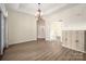 Bright dining room featuring modern floors, a decorative chandelier, and easy access to other living spaces at 10502 Old Ardrey Kell Rd, Charlotte, NC 28277