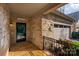 Covered front entrance with stone accents, black front door, 'Welcome' sign and iron railing details at 10502 Old Ardrey Kell Rd, Charlotte, NC 28277