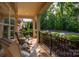 Inviting front porch with comfortable seating, manicured landscaping, iron railings and plenty of natural light at 10502 Old Ardrey Kell Rd, Charlotte, NC 28277