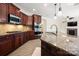 Spacious kitchen with cherry cabinets, granite countertops, stainless steel appliances, and an eat-in island at 10502 Old Ardrey Kell Rd, Charlotte, NC 28277