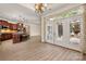 Well-lit kitchen and dining area with stainless appliances, a large island, and access to the outdoor patio at 10502 Old Ardrey Kell Rd, Charlotte, NC 28277