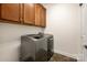 Laundry room with modern washer and dryer and convenient upper cabinets at 10502 Old Ardrey Kell Rd, Charlotte, NC 28277