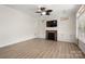 Light filled living room featuring a fireplace with built-in shelving, recessed lighting, and large windows at 10502 Old Ardrey Kell Rd, Charlotte, NC 28277