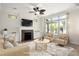 Bright living room features a fireplace with marble surround and lots of natural light at 10502 Old Ardrey Kell Rd, Charlotte, NC 28277