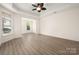 Spacious living room featuring recessed lighting, modern floors, a tray ceiling, and large windows for natural light at 10502 Old Ardrey Kell Rd, Charlotte, NC 28277