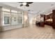 Open living room featuring a fireplace, large windows with decorative curtains, and access to the kitchen at 10502 Old Ardrey Kell Rd, Charlotte, NC 28277