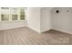Bright living space with natural light, and modern wood-look flooring at 10502 Old Ardrey Kell Rd, Charlotte, NC 28277