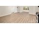 Open-concept living space with kitchenette and modern wood-look flooring at 10502 Old Ardrey Kell Rd, Charlotte, NC 28277