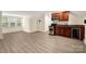 Cozy living space with kitchenette, natural light, and wood-look floors at 10502 Old Ardrey Kell Rd, Charlotte, NC 28277