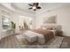 Spacious main bedroom boasts neutral tones, tray ceiling, and sitting area at 10502 Old Ardrey Kell Rd, Charlotte, NC 28277