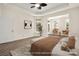 Airy main bedroom features lots of space, neutral decor, and lots of natural light at 10502 Old Ardrey Kell Rd, Charlotte, NC 28277