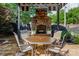 Back patio area with outdoor seating, a stone floor and a view of the outdoor fireplace at 10502 Old Ardrey Kell Rd, Charlotte, NC 28277