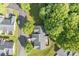 Scenic aerial view of a home surrounded by lush greenery and mature trees in a quiet neighborhood at 112 Dujon Ct, Mount Holly, NC 28120
