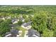 Expansive aerial view of a residential neighborhood surrounded by lush trees and greenery at 112 Dujon Ct, Mount Holly, NC 28120