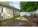 Secluded backyard features a stone walkway, white fence, and lush landscaping at 112 Dujon Ct, Mount Holly, NC 28120