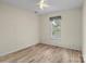 Neutral bedroom with a window and hardwood flooring; the room is empty and ready to be furnished at 112 Dujon Ct, Mount Holly, NC 28120