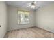 Neutral bedroom with a window and hardwood flooring; the room is empty and ready to be furnished at 112 Dujon Ct, Mount Holly, NC 28120