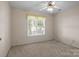 Neutral bedroom with a window and carpet flooring; the room is empty and ready to be furnished at 112 Dujon Ct, Mount Holly, NC 28120