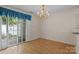 Bright dining area with hardwood floors, chandelier lighting, and sliding glass doors to the outside at 112 Dujon Ct, Mount Holly, NC 28120
