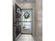 Showing the entrance with a black front door, screen door and tile flooring at 112 Dujon Ct, Mount Holly, NC 28120