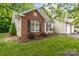 A close exterior view showing the home's brick accents, siding, and a landscaped front garden at 112 Dujon Ct, Mount Holly, NC 28120