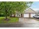 Single-story home with attached garage, mature tree, and manicured lawn at 112 Dujon Ct, Mount Holly, NC 28120