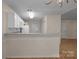 Open kitchen with white cabinetry and a breakfast bar overlooking an adjacent room at 112 Dujon Ct, Mount Holly, NC 28120