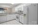 White kitchen with stainless steel sink, range, microwave, and refrigerator at 112 Dujon Ct, Mount Holly, NC 28120