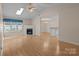 Bright living space with hardwood floors, a fireplace, and an open layout to the dining area at 112 Dujon Ct, Mount Holly, NC 28120