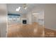 Open-concept living room featuring hardwood floors, a fireplace, and seamless flow to other rooms at 112 Dujon Ct, Mount Holly, NC 28120